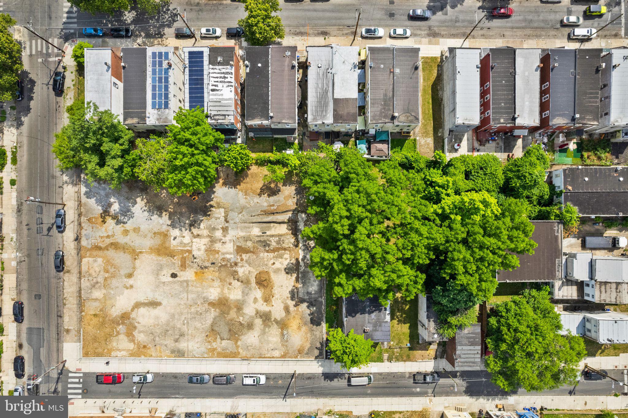 a view of a tall brick building next to a yard