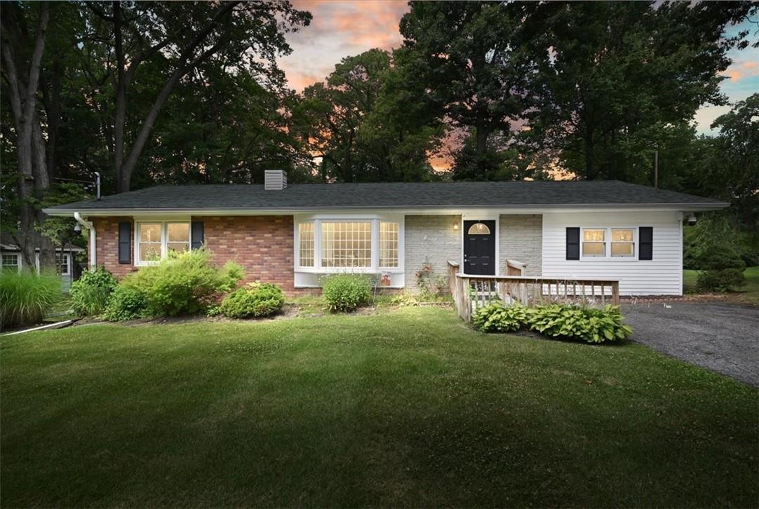 a front view of a house with a garden