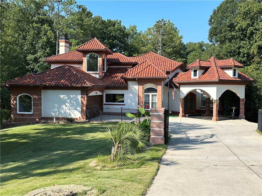 a front view of a house with a garden