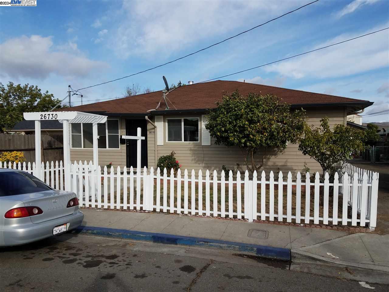 a front view of a house with a garden