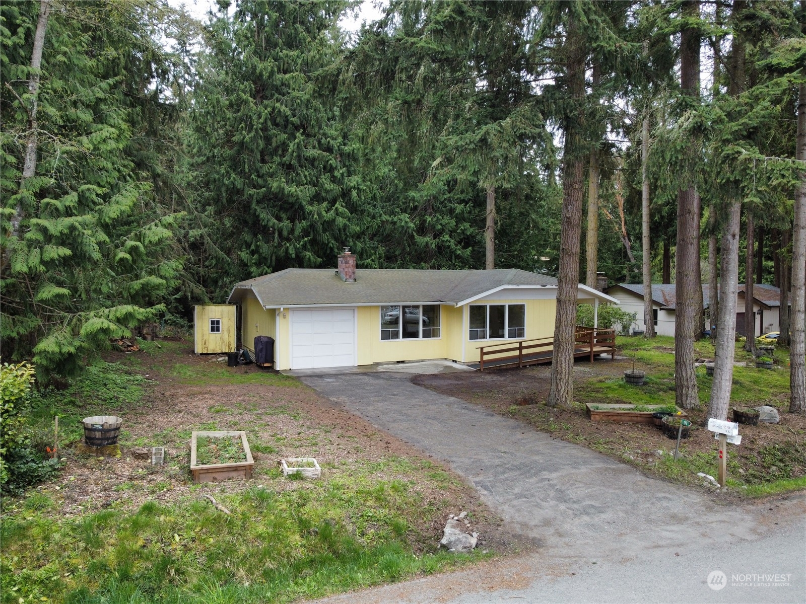 a front view of a house with a garden