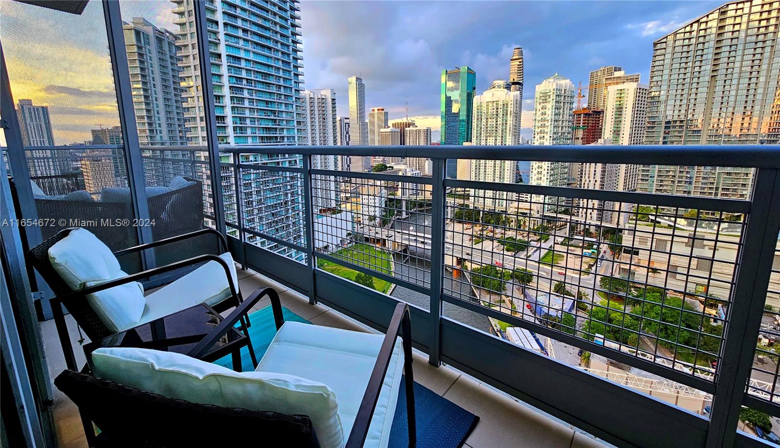 a view of a balcony with two chairs and a wooden floor