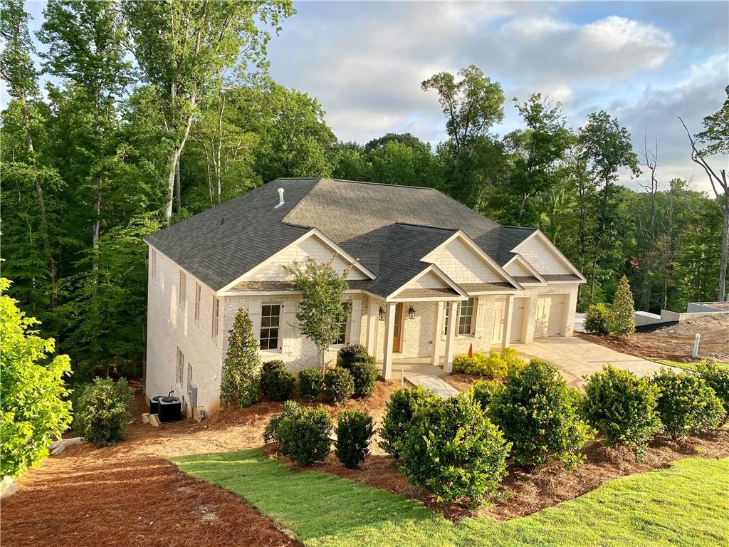 a front view of a house with a garden