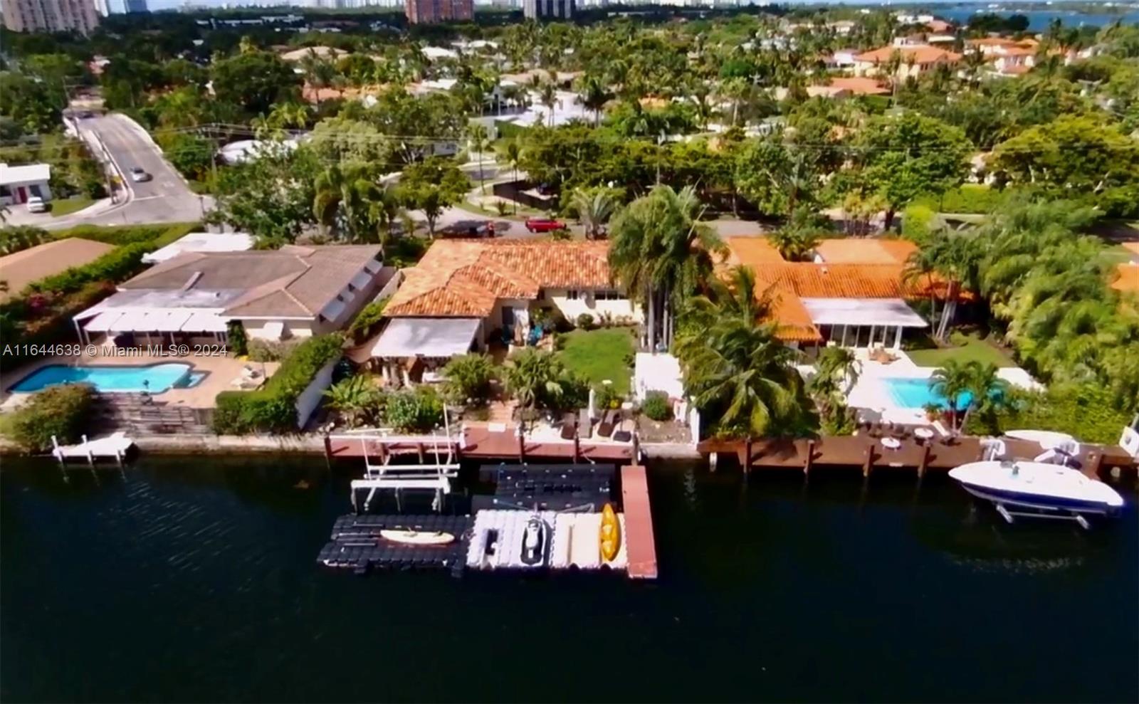 an aerial view of a swimming pool with outdoor seating