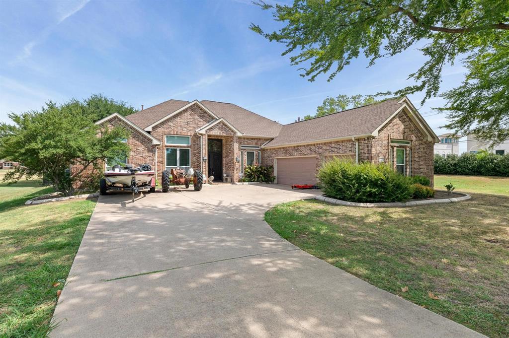 a front view of a house with a yard and a garden