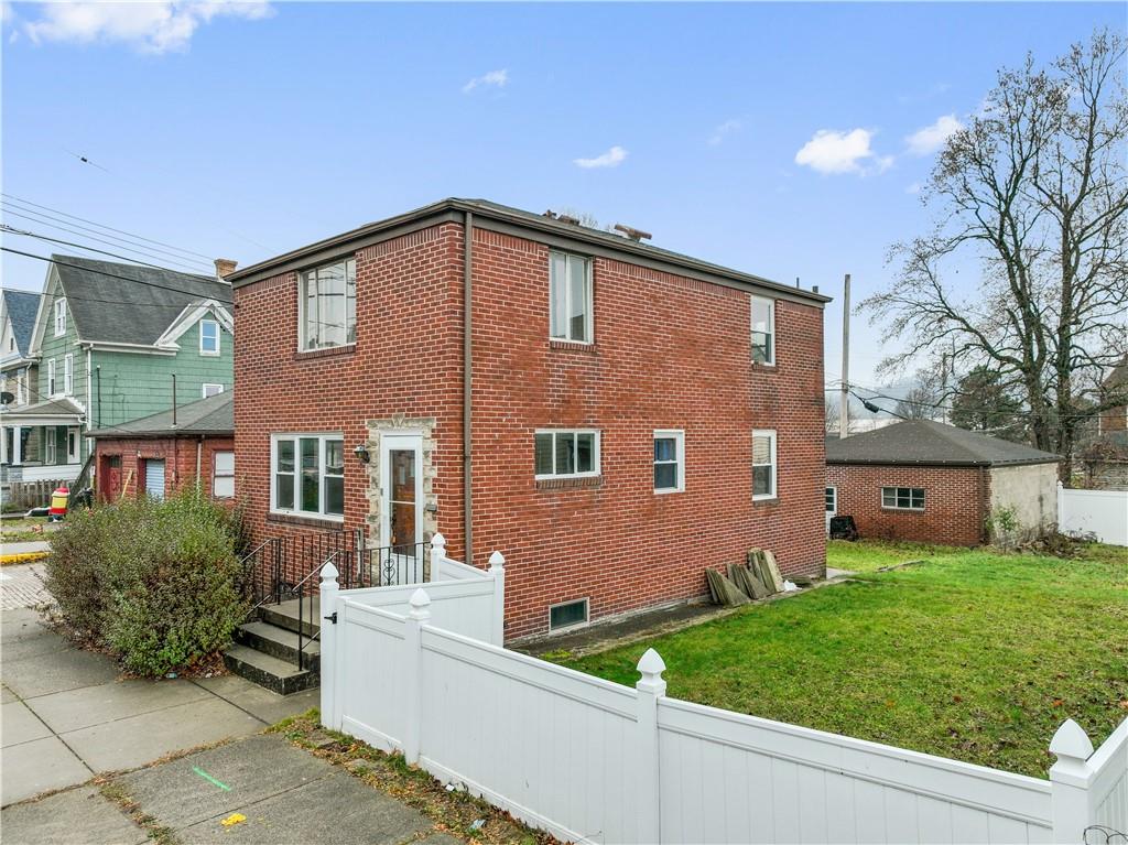 Solid Brick Home Situated on a Double Lot in the Heart of Ambridge.