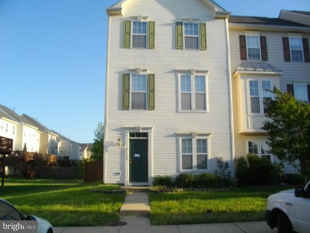 a front view of a house with a yard and outdoor seating