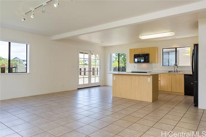 a kitchen with granite countertop a stove a sink and a granite counter tops