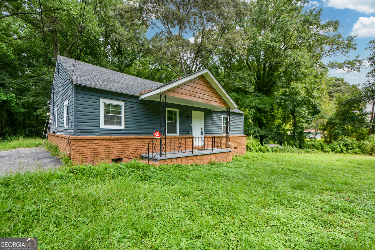 a front view of a house with a yard and porch