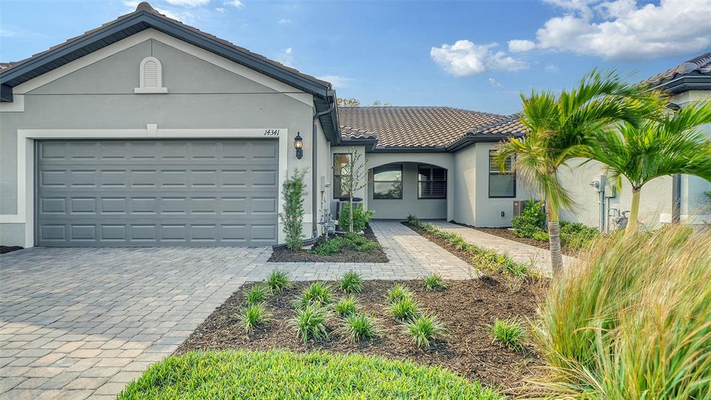 a front view of a house with a yard and garage