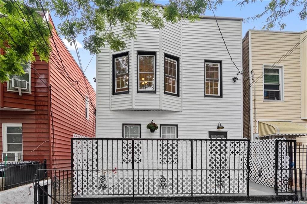 a view of a house with a wooden fence