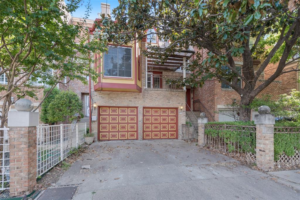 a view of a house with a tree in front of it