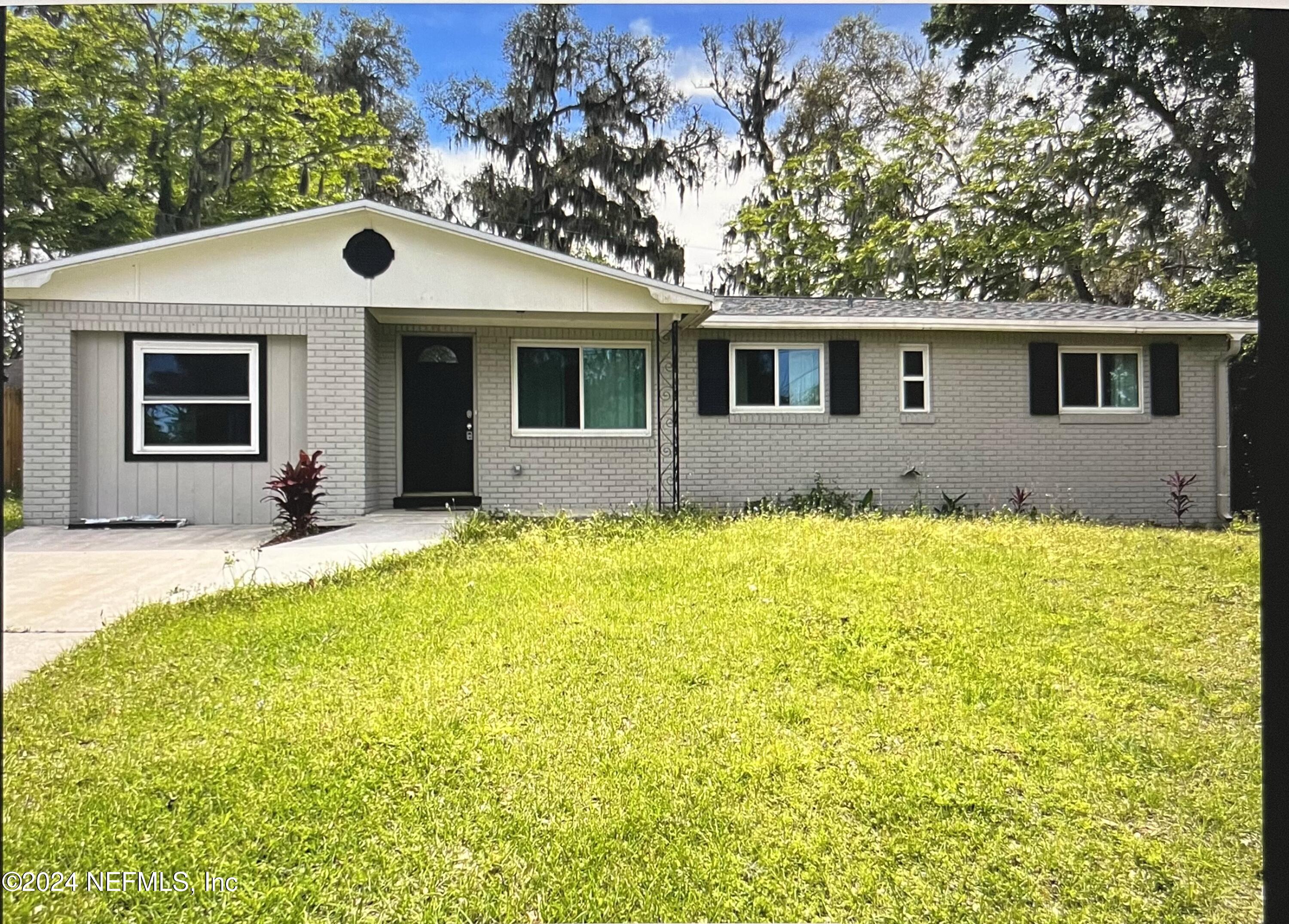 a front view of house with yard outdoor seating and yard