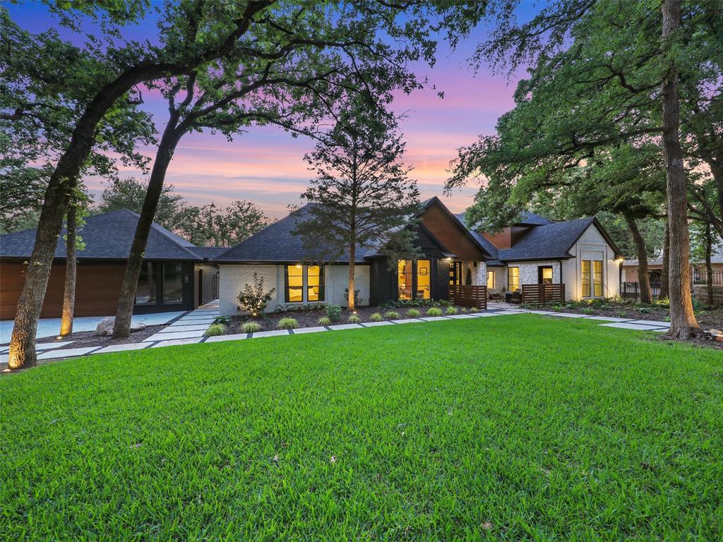 a front view of a house with garden and sitting area