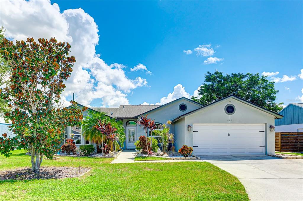 a front view of house with yard and outdoor seating