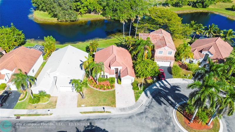 an aerial view of a house with outdoor space and a lake view