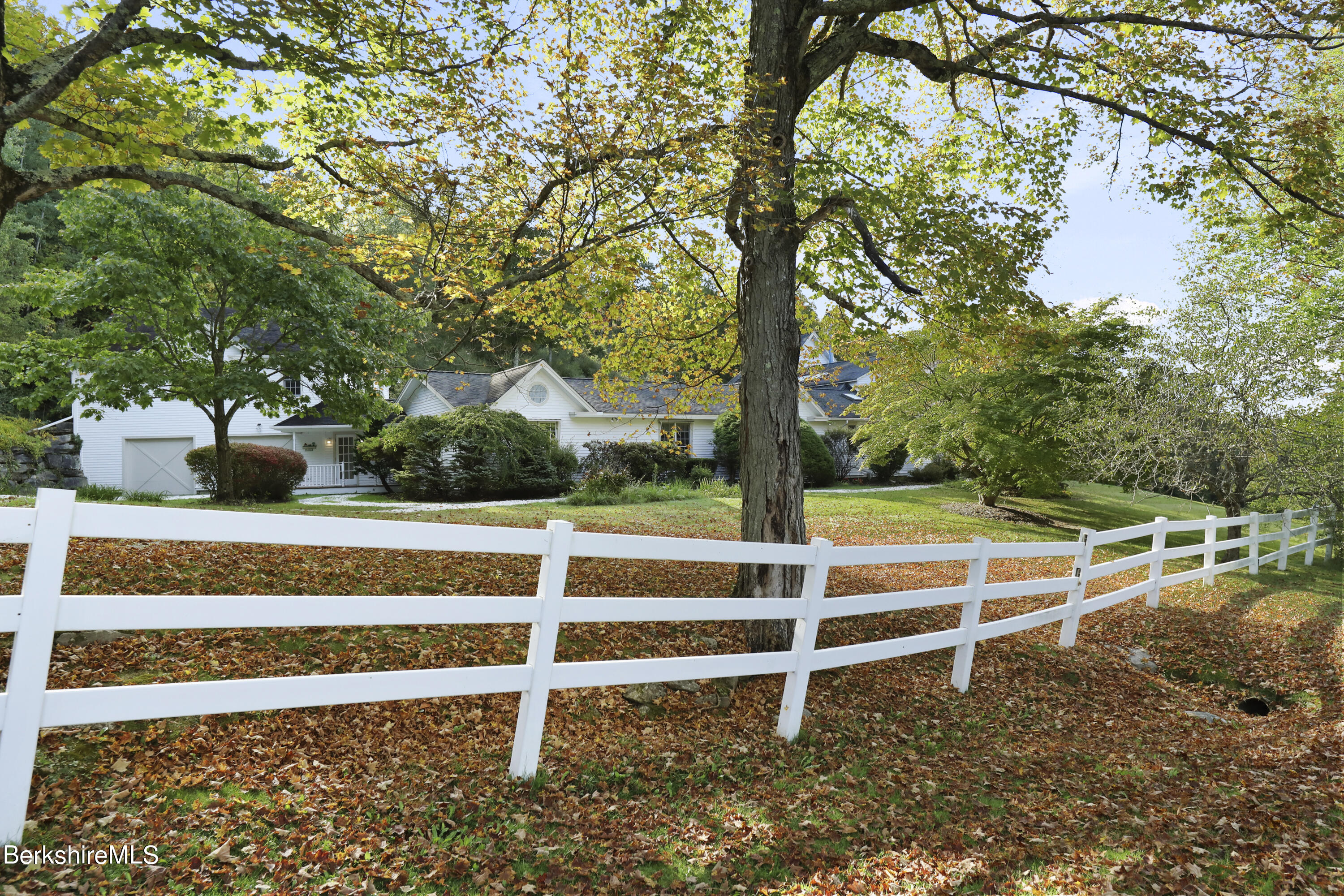 a view of a yard with wooden fence