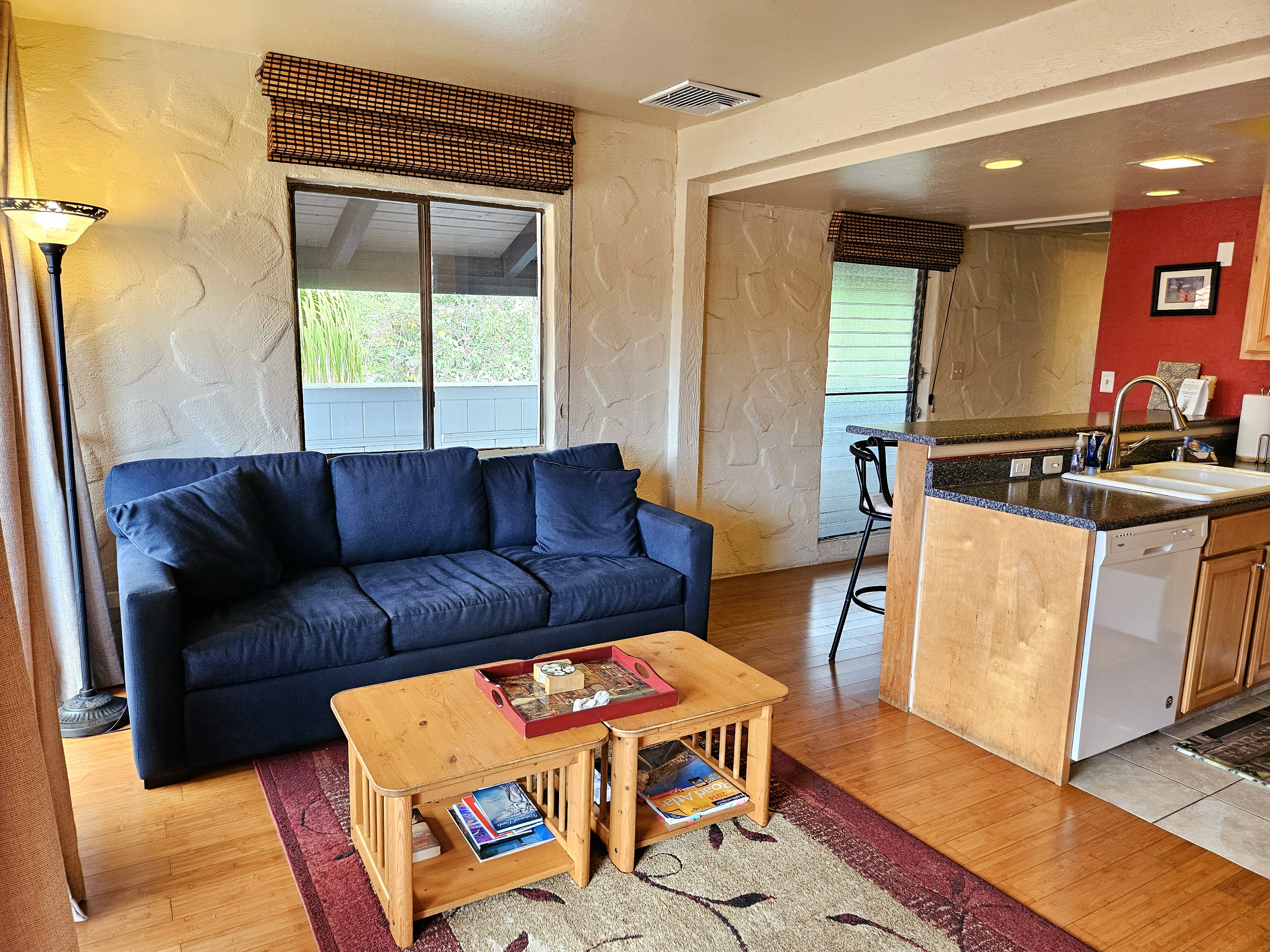 a living room with furniture a flat screen tv and a large window