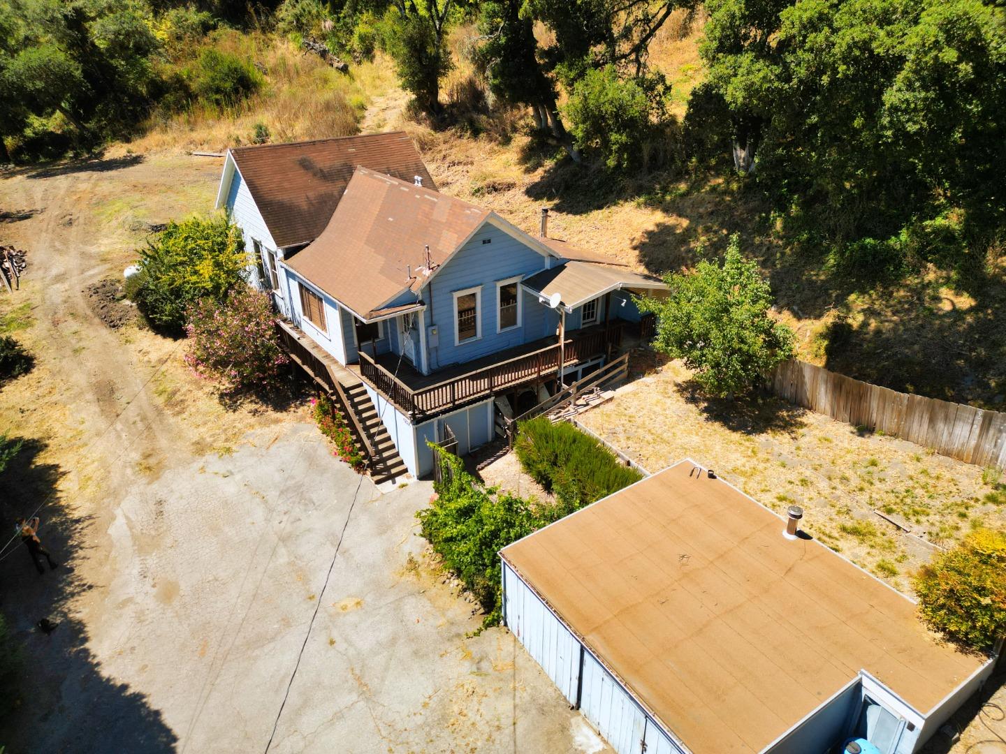 a view of a backyard with wooden fence