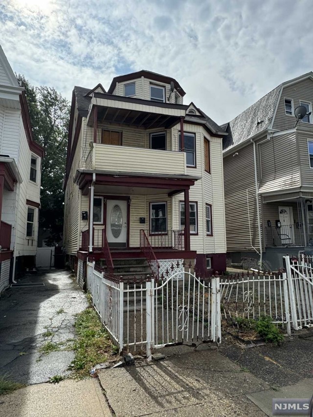 a front view of a house with wooden fence