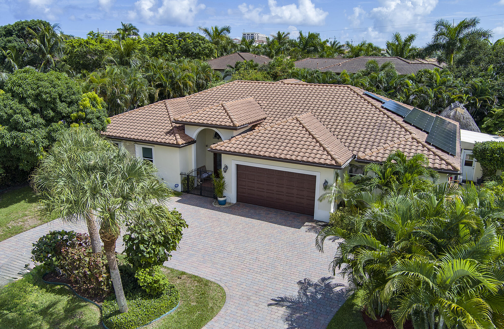 an aerial view of a house with a yard and potted plants