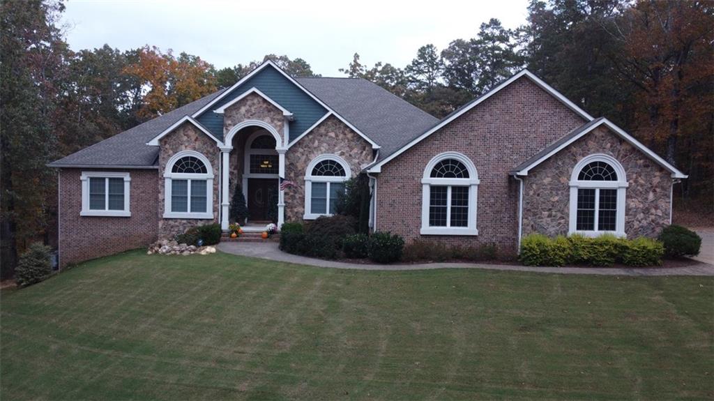 a front view of a house with a garden