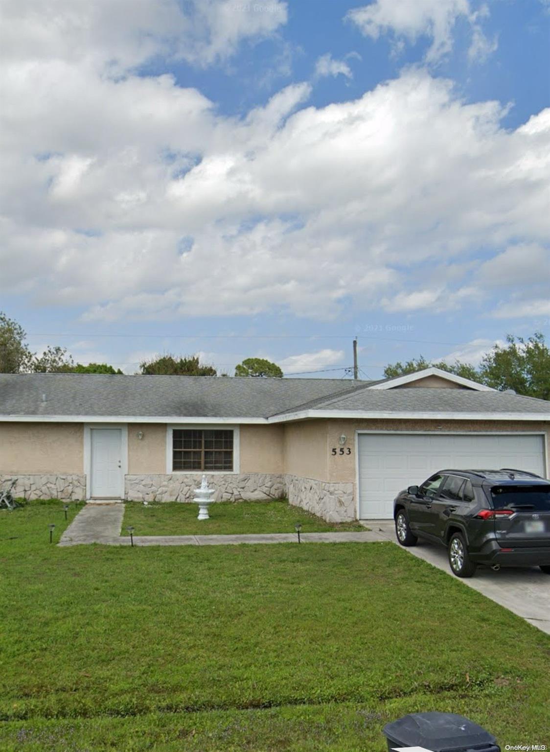 a view of a car park in front of a house