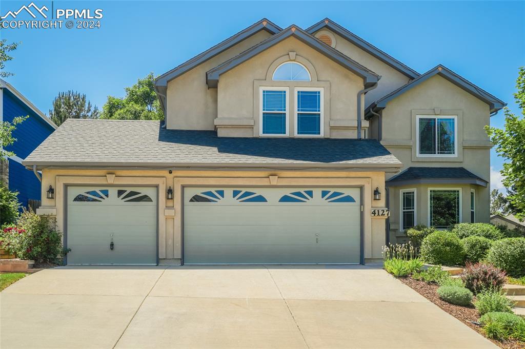 a front view of a house with a garage