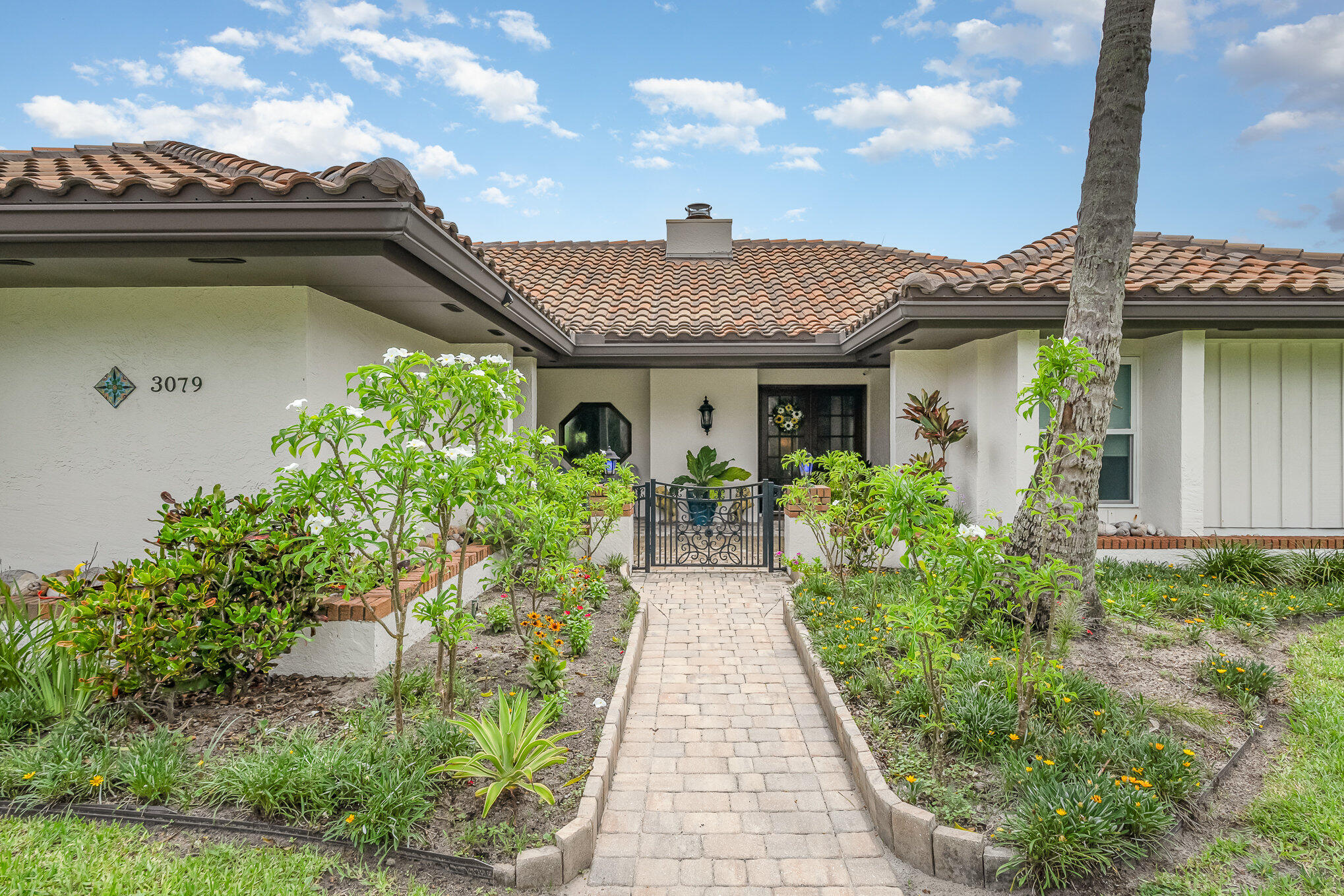 a front view of a house with garden