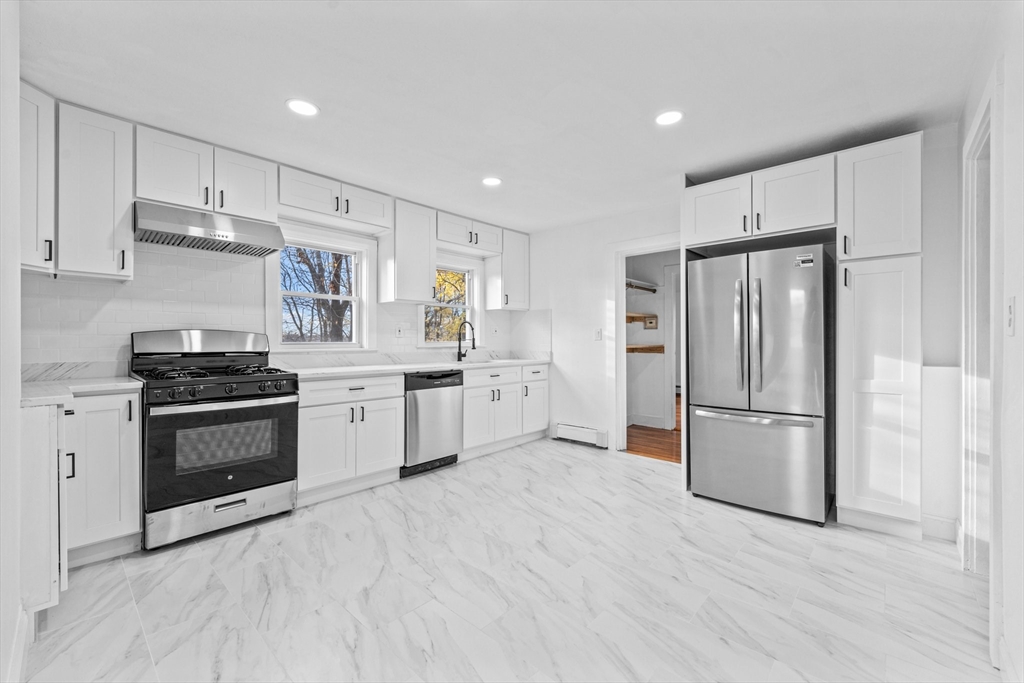 a kitchen with stainless steel appliances a refrigerator sink and cabinets