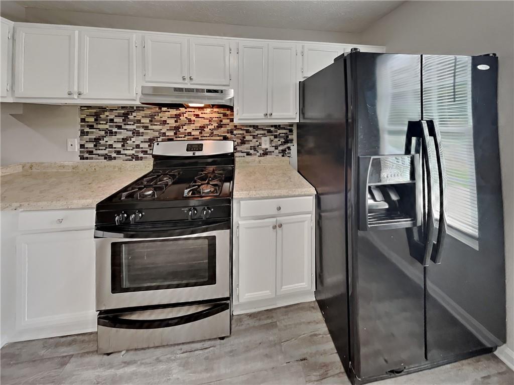 a kitchen with a stove microwave and refrigerator