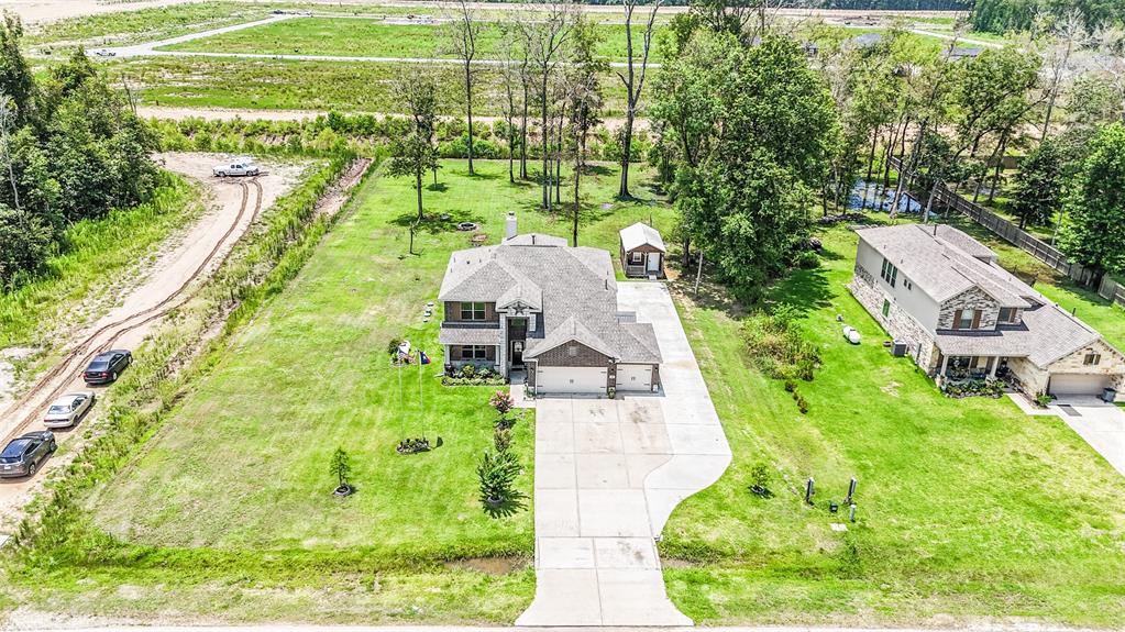 an aerial view of a house with big yard