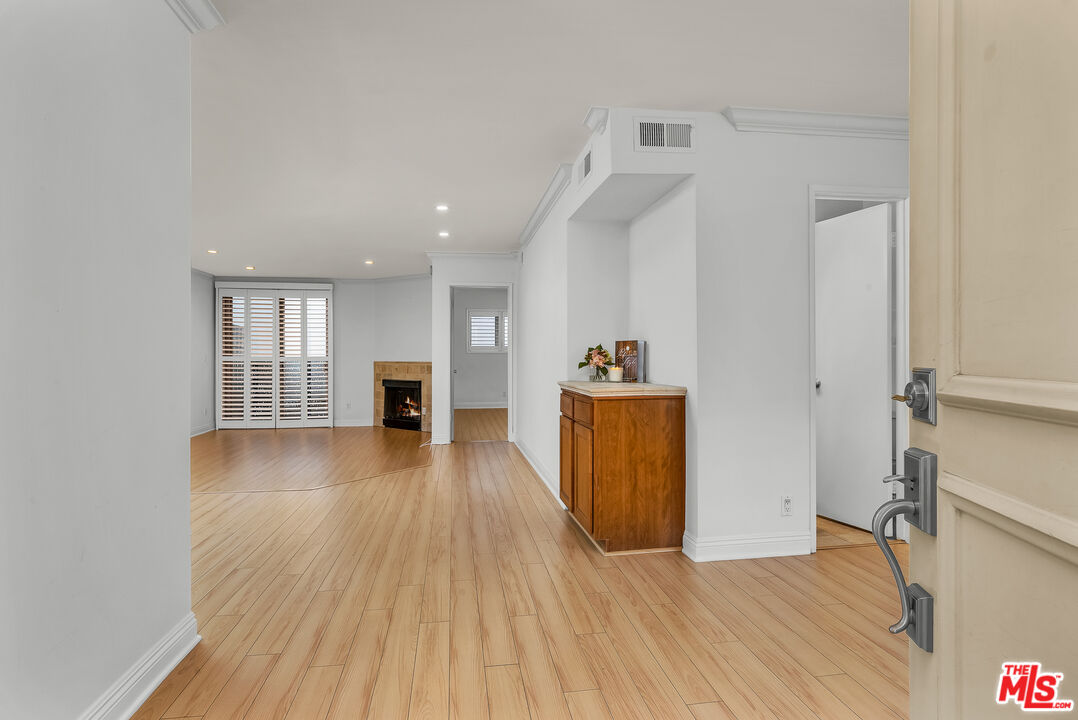 a view of a room with wooden floor and a window