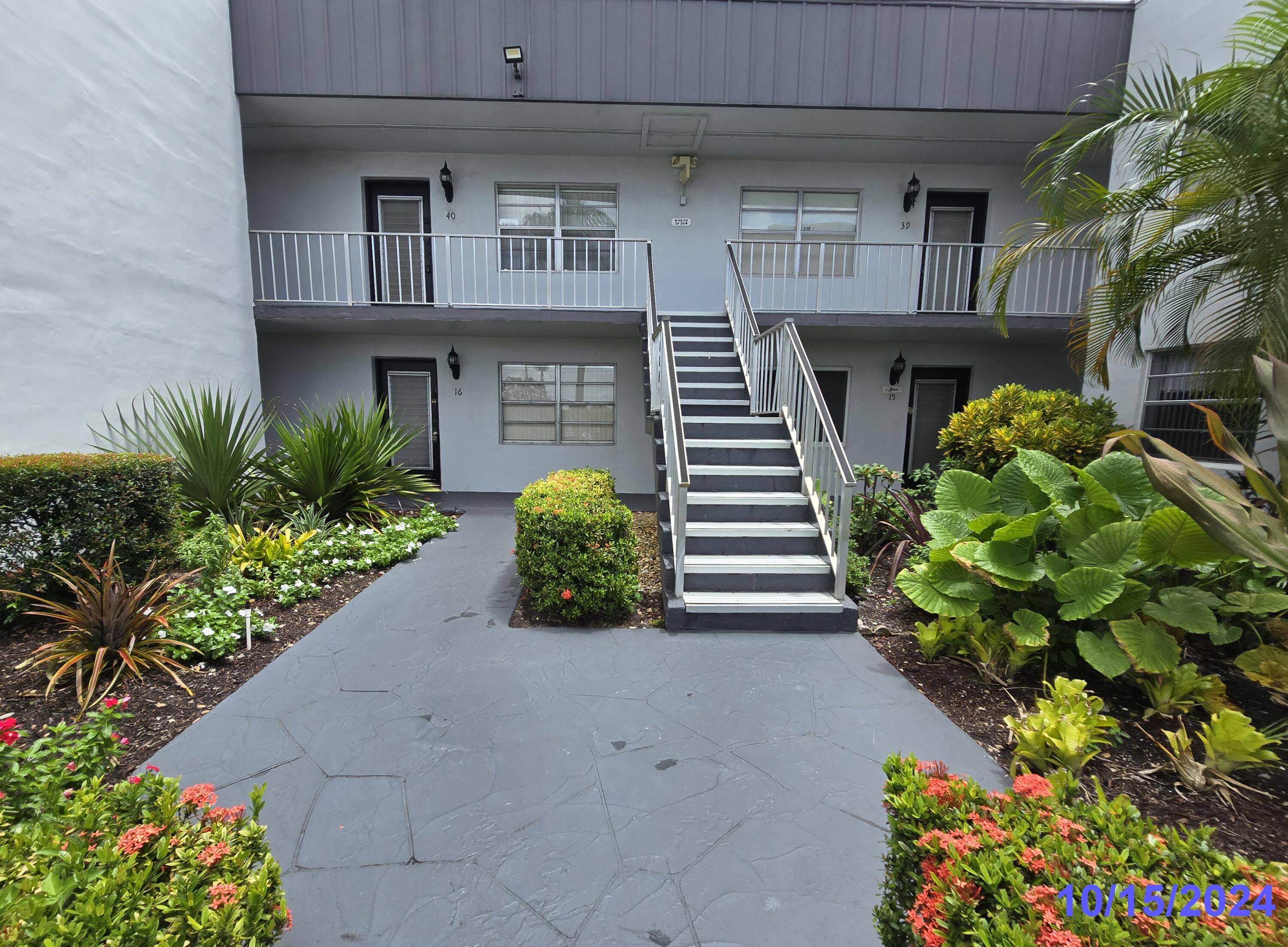 a view of a house with potted plants