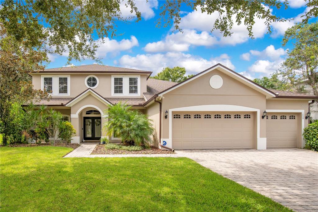 a front view of a house with a yard and garage