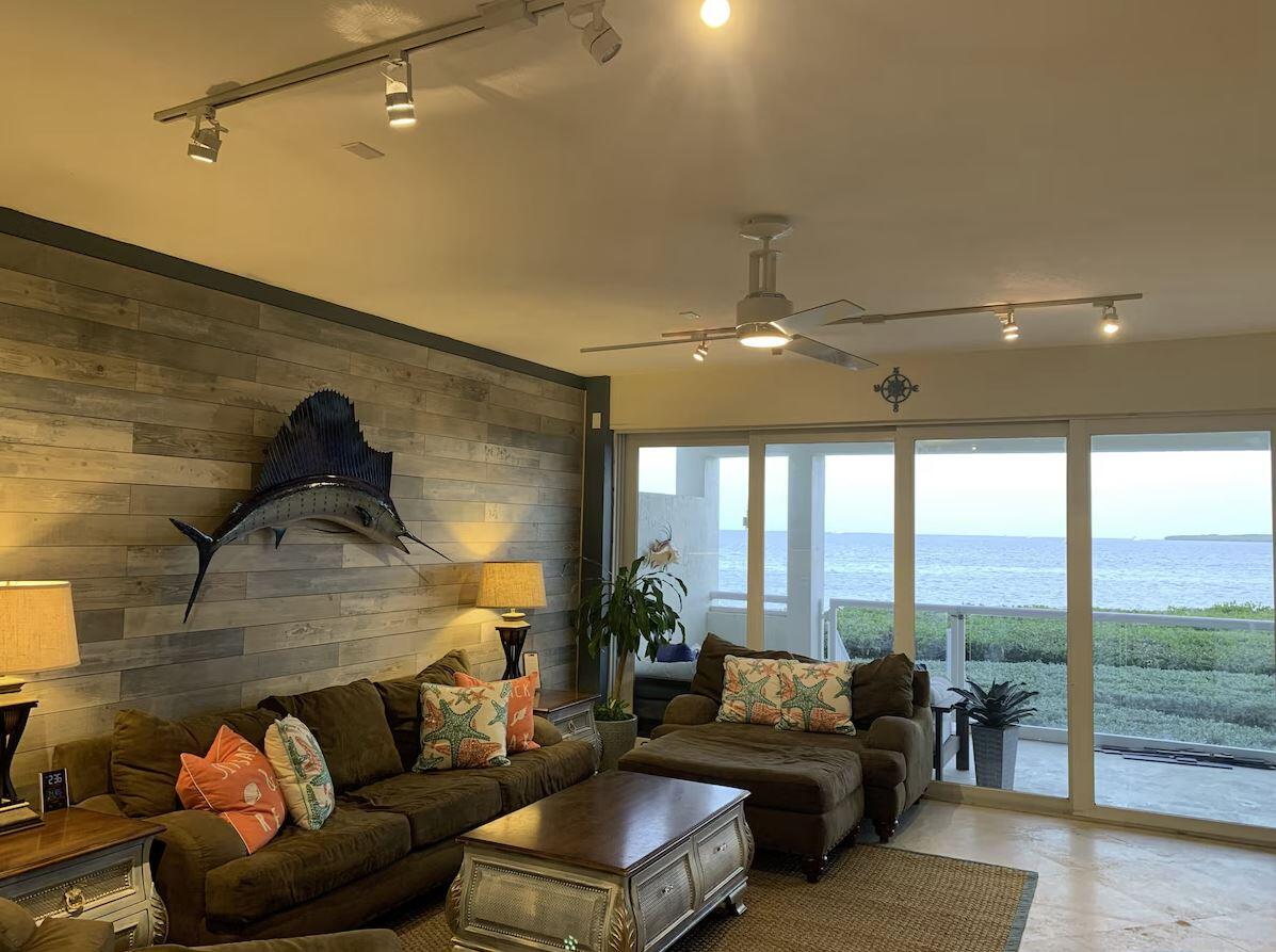 a living room with furniture and a ceiling fan