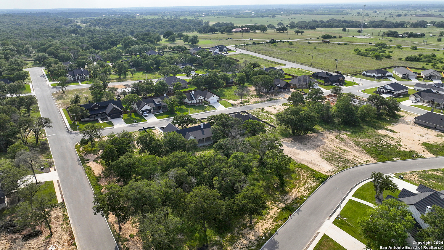 an aerial view of river residential houses with outdoor space and trees