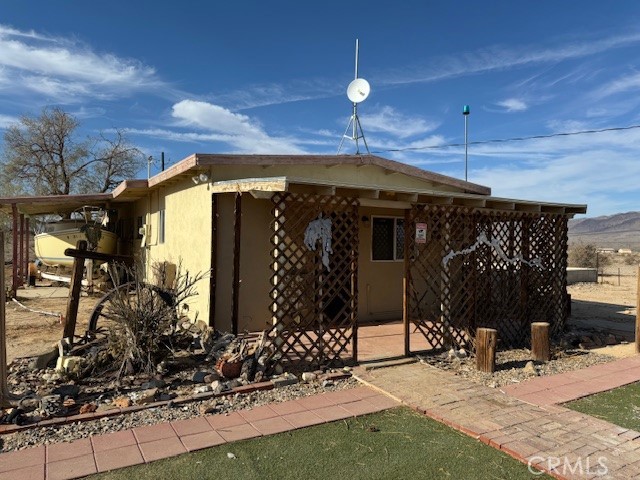 a view of a house with yard and sitting area