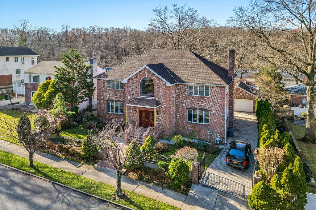 a aerial view of a house with a yard and potted plants