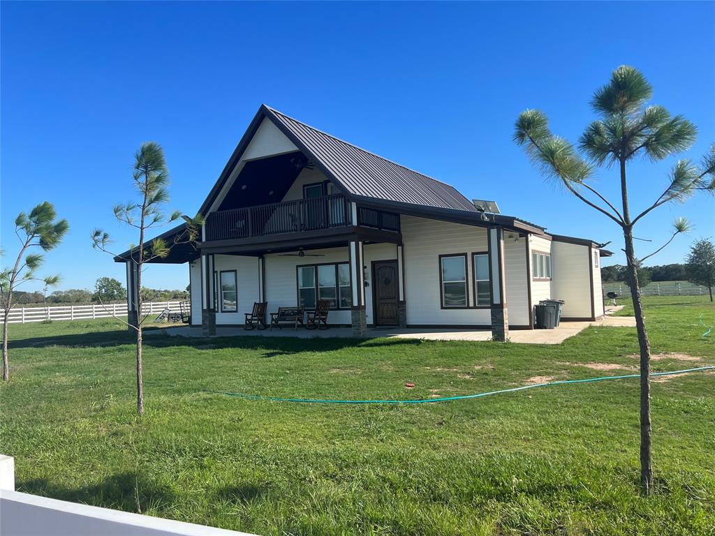 a view of a house with a yard porch and sitting area