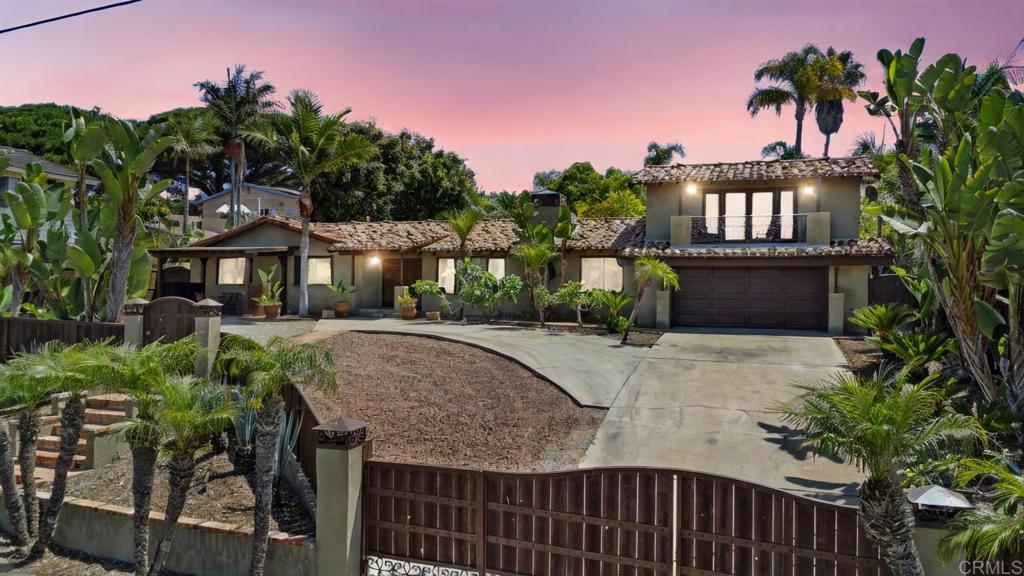 a view of a house with a yard and potted plants