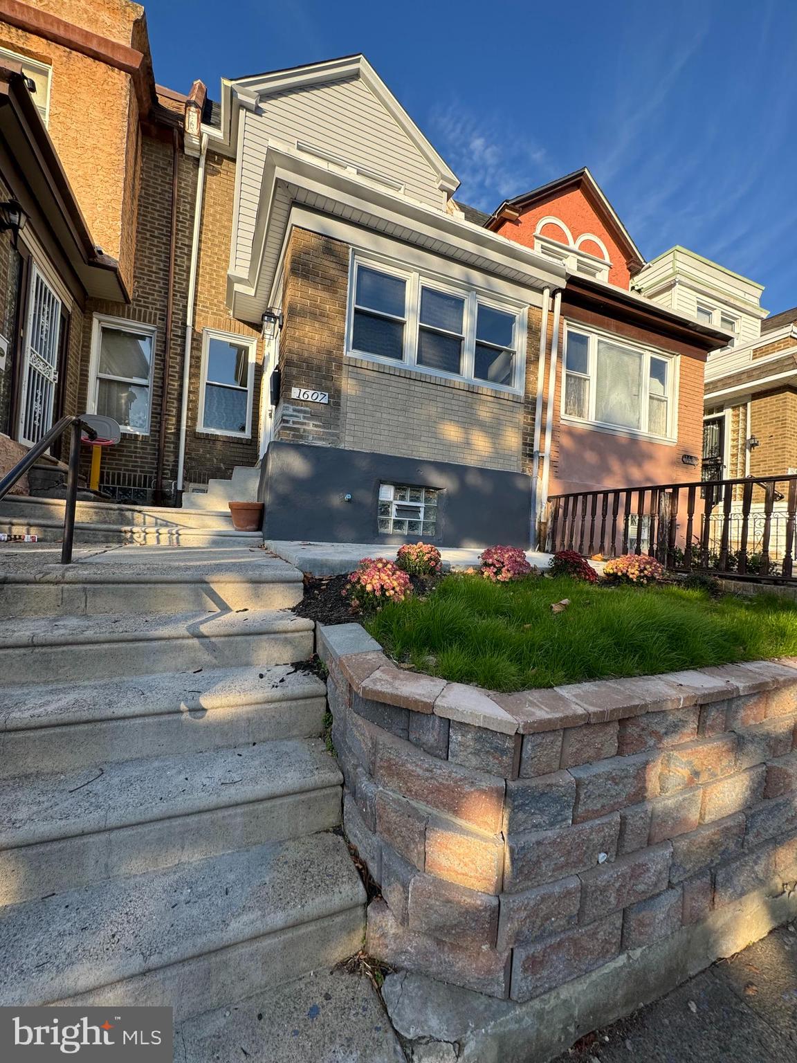 a front view of a house with a garden