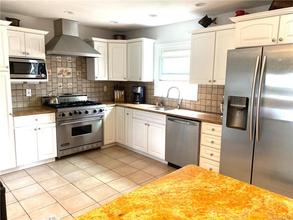 a kitchen with a stove a sink and a refrigerator