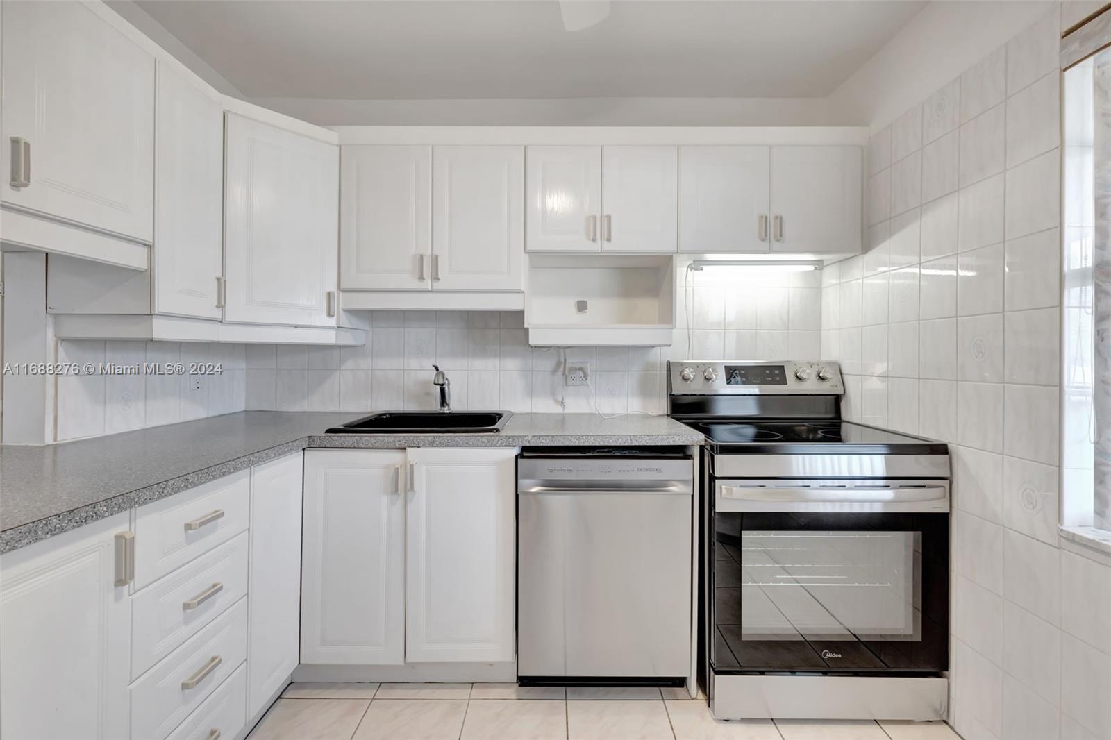 a kitchen with cabinets appliances and a sink