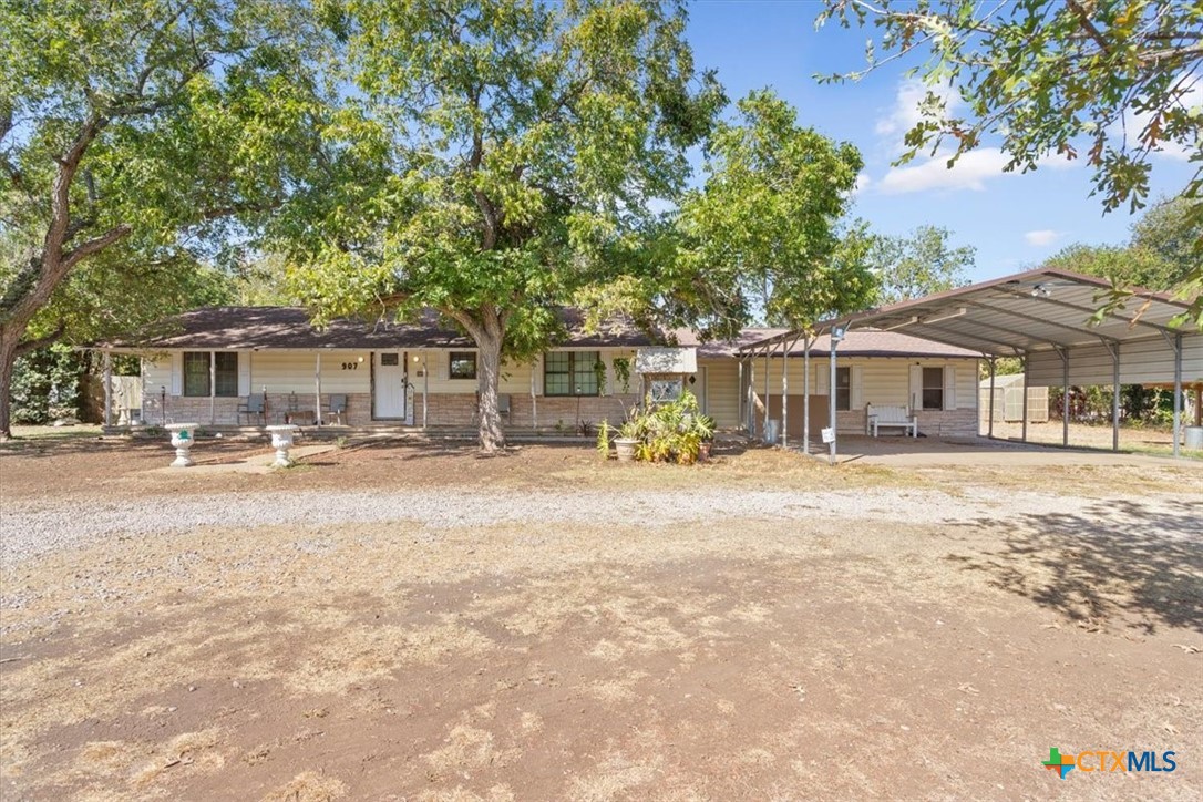 a front view of a house with a yard and a garage