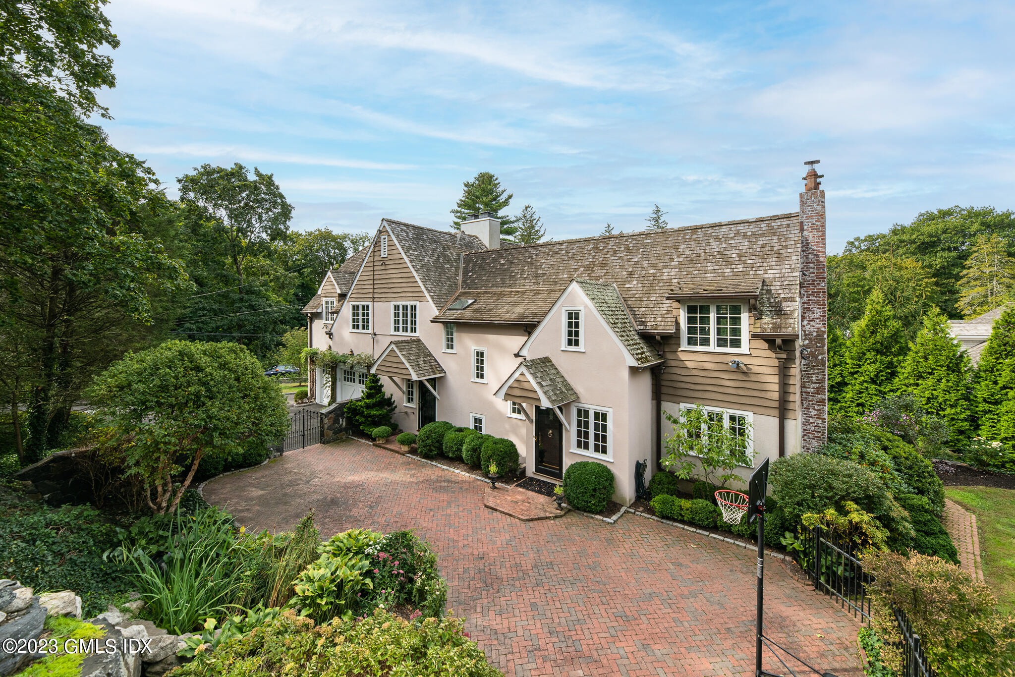 a front view of a house with a yard and potted plants