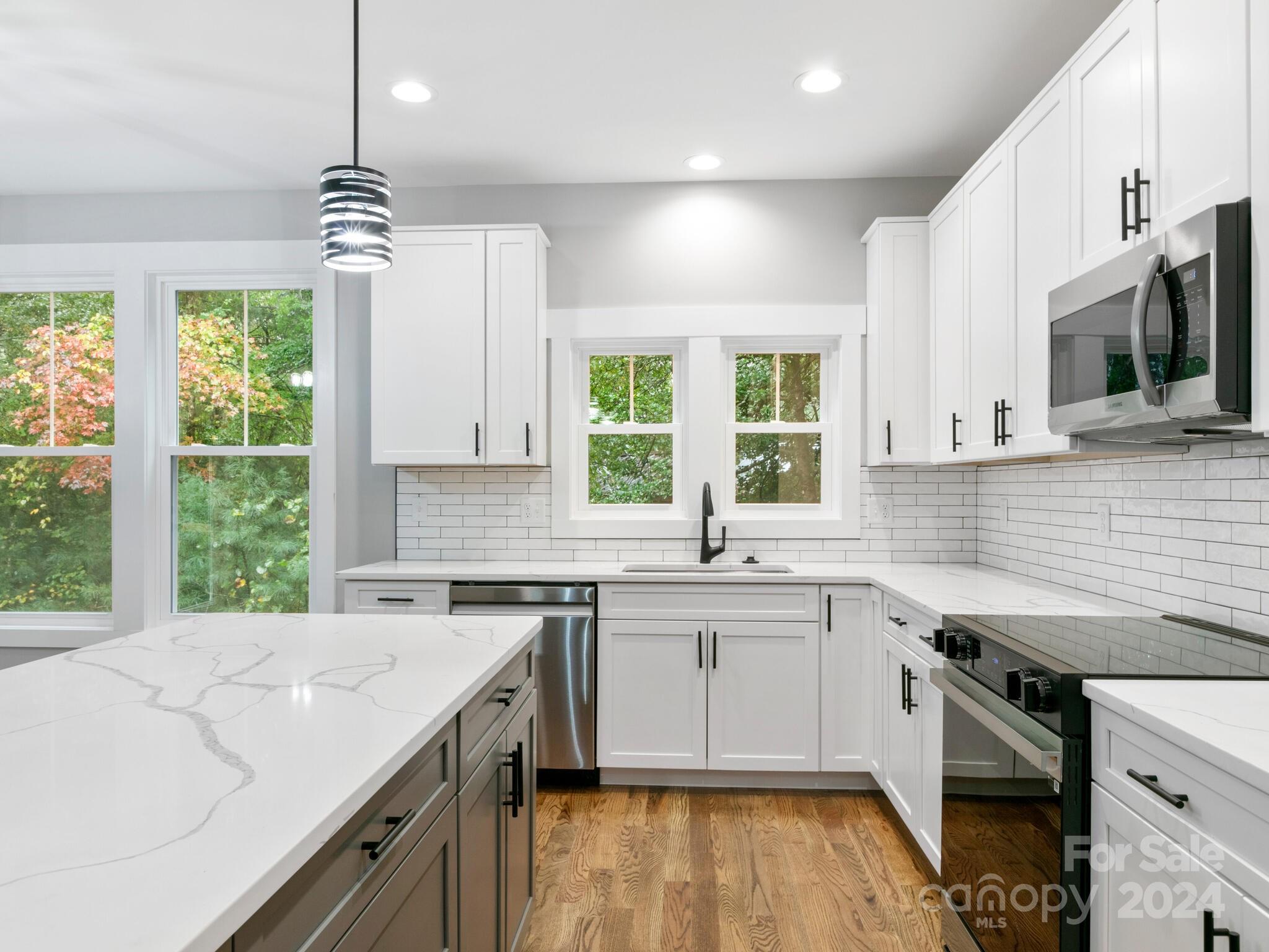 a kitchen with a sink stove and microwave