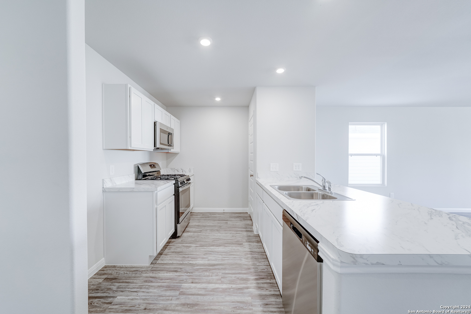 a kitchen with a sink stove and refrigerator