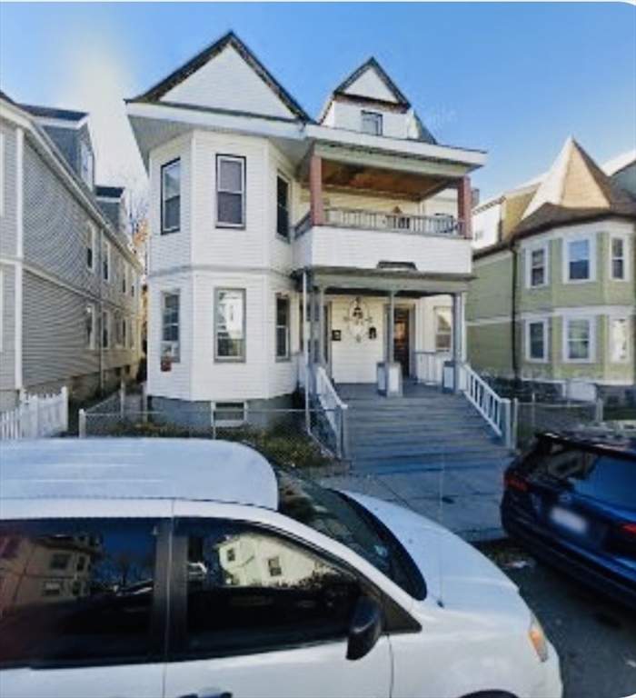 a front view of a house with parking space