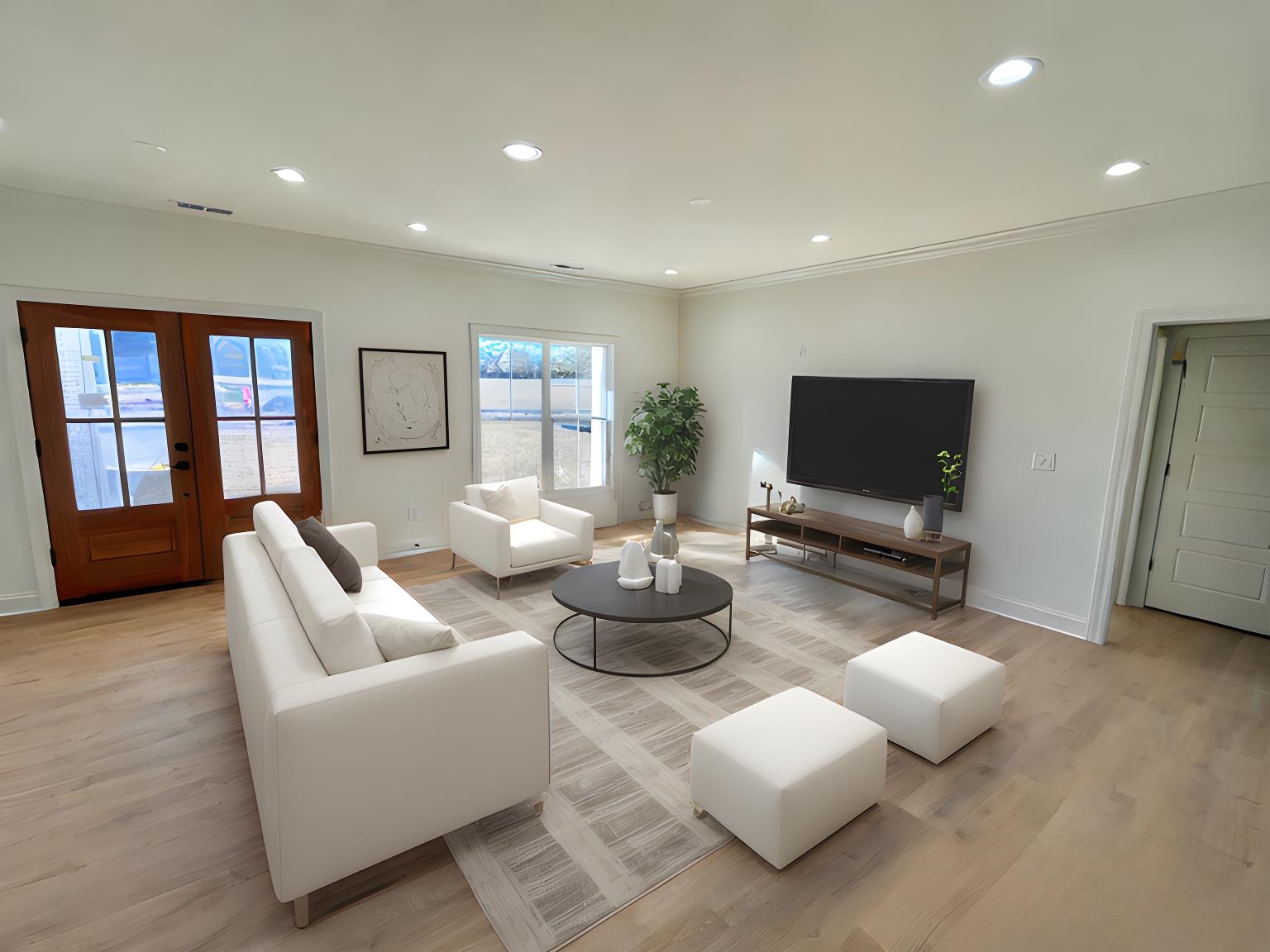 Living room with light wood-type flooring, ornamental molding, and french doors